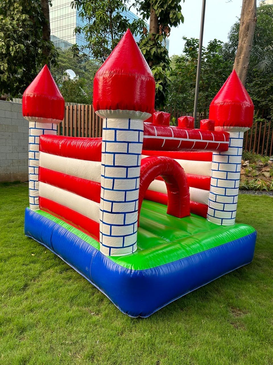 Bright red castle-themed bounce house for children’s parties