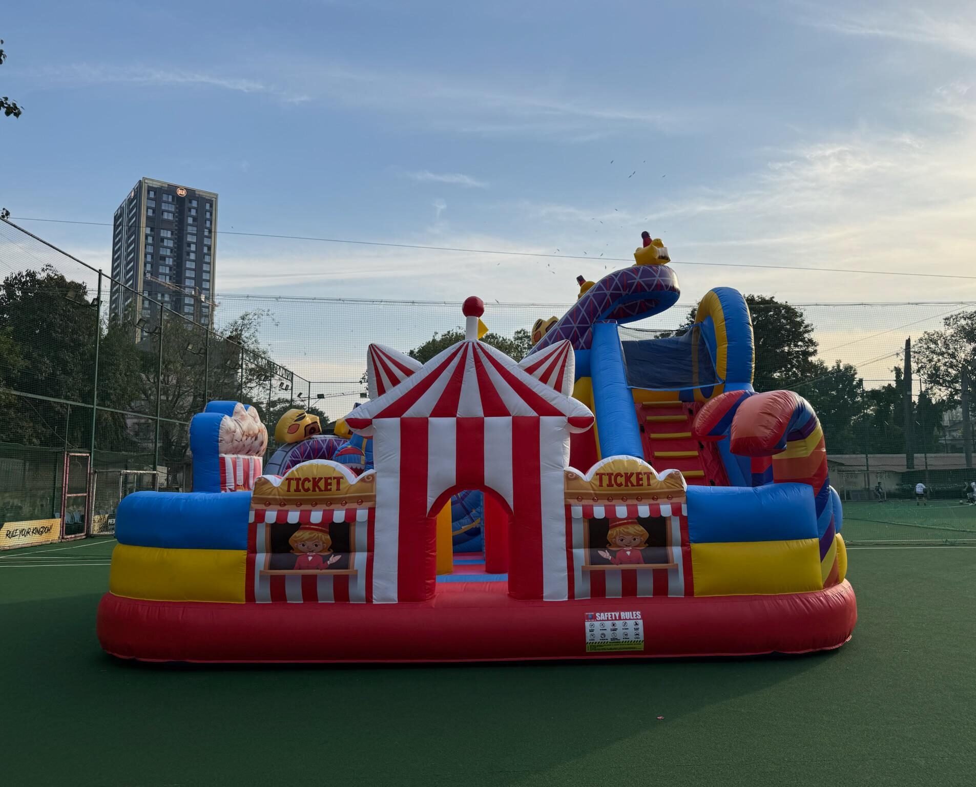 Colorful carnival fun city bounce house with slides and play area