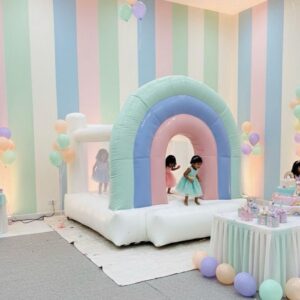 Soft pastel inflatable bounce house with gentle colors