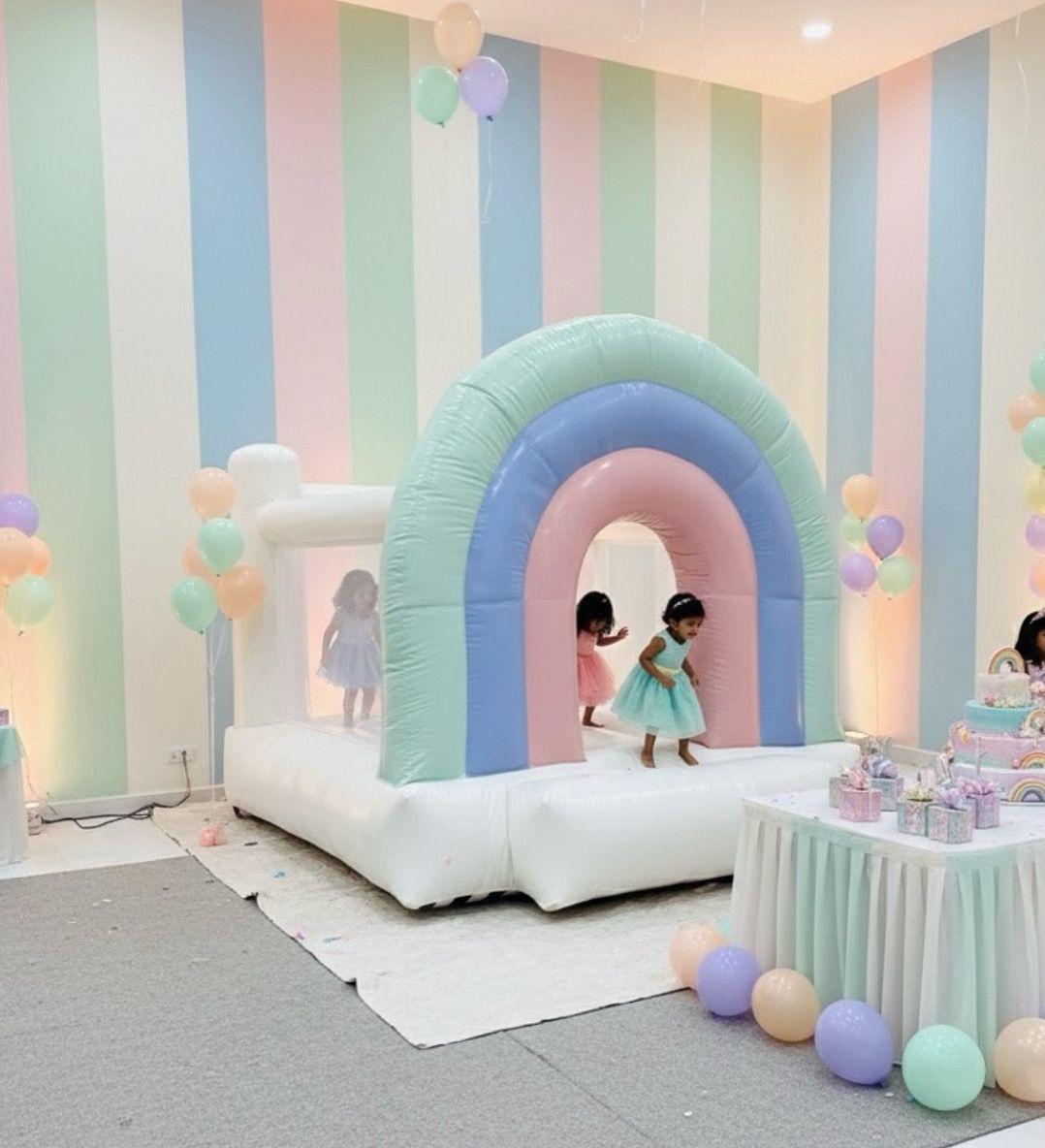 Soft pastel inflatable bounce house with gentle colors