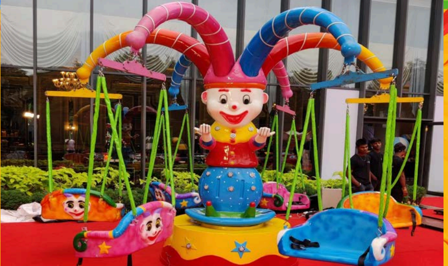 Colorful Joker-themed swing ride for children